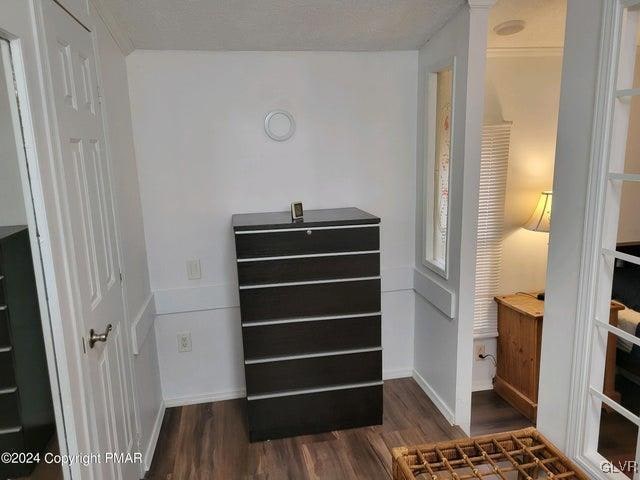 bedroom with dark wood-type flooring