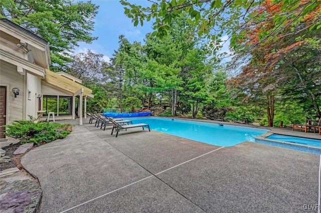 view of pool featuring an in ground hot tub and a patio