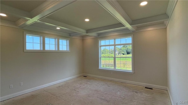 unfurnished room with coffered ceiling, plenty of natural light, and beam ceiling