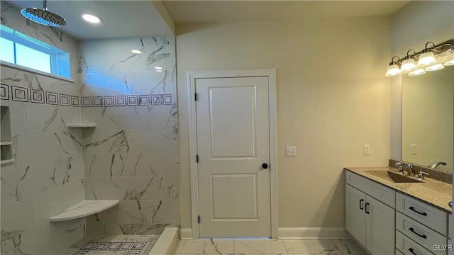 bathroom with tile patterned floors, a tile shower, and vanity