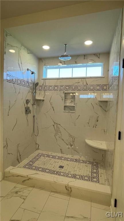 bathroom featuring tile patterned floors and a tile shower