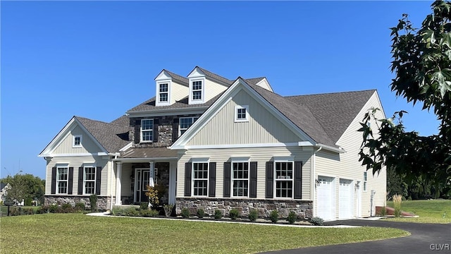 craftsman inspired home featuring a front lawn and a garage