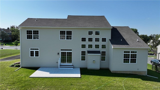 back of property featuring a patio area and a yard