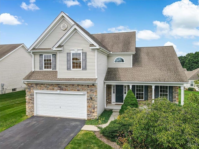 view of front of house with a garage and a front yard