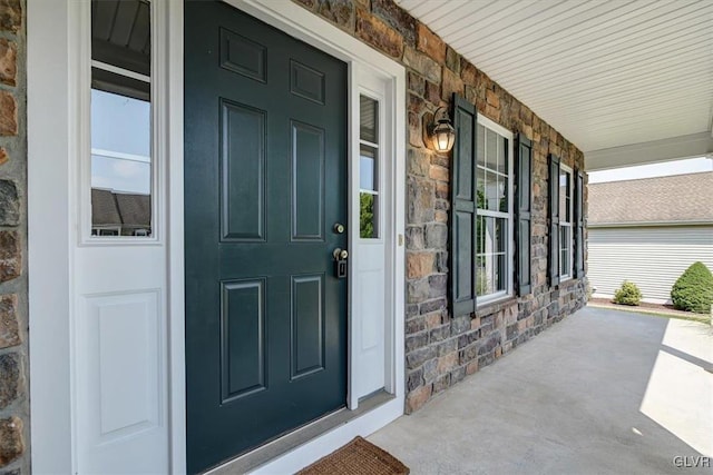 doorway to property featuring covered porch