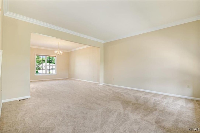 spare room featuring a notable chandelier, light carpet, and ornamental molding