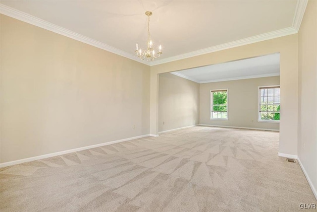 spare room with light colored carpet, a chandelier, and ornamental molding