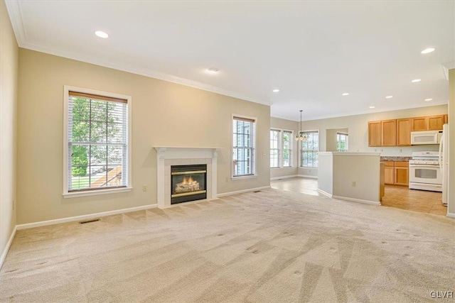 unfurnished living room featuring an inviting chandelier, a tiled fireplace, light tile patterned floors, and crown molding