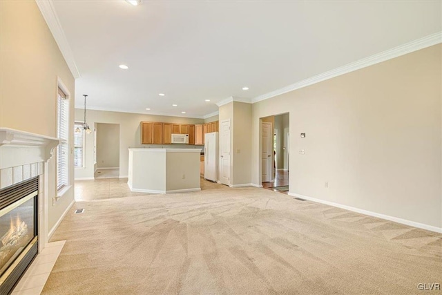 unfurnished living room featuring crown molding, a fireplace, and light colored carpet