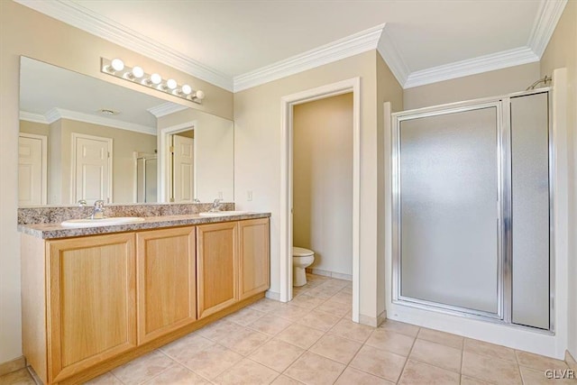 bathroom featuring ornamental molding, dual vanity, toilet, and a shower with shower door