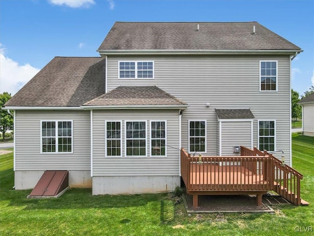 back of house with a deck and a yard