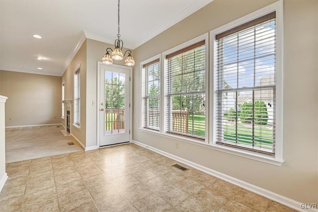 foyer entrance with a healthy amount of sunlight, a notable chandelier, and light tile patterned floors