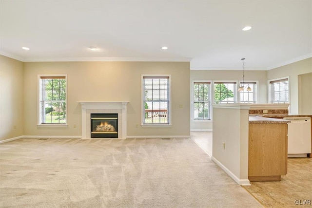 unfurnished living room with a fireplace, ornamental molding, and light colored carpet