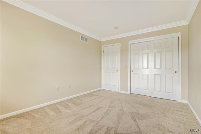 unfurnished bedroom featuring carpet floors and crown molding