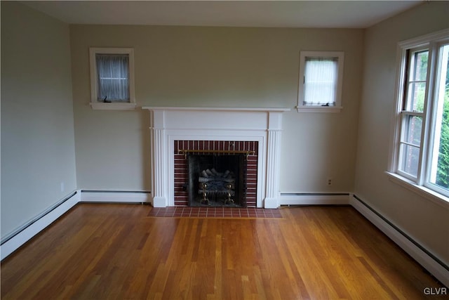 unfurnished living room featuring a baseboard radiator, a brick fireplace, baseboard heating, and wood finished floors