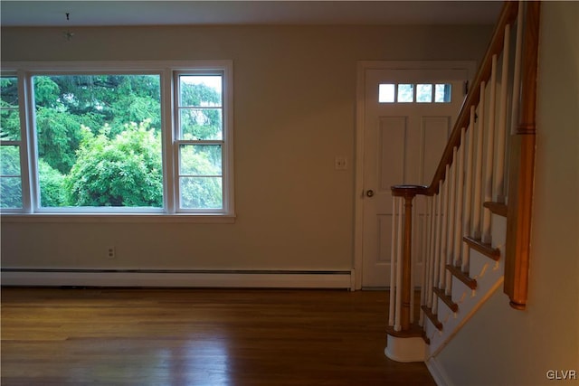 foyer featuring stairs, a baseboard radiator, plenty of natural light, and wood finished floors