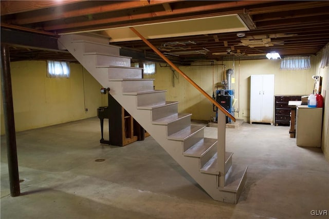 basement with stairs and a heating unit