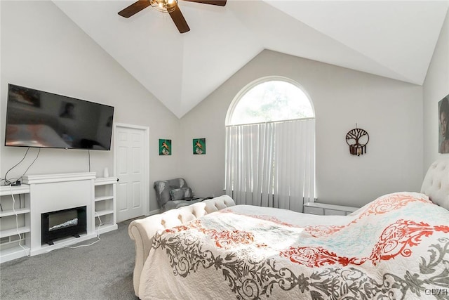 carpeted bedroom featuring ceiling fan and vaulted ceiling