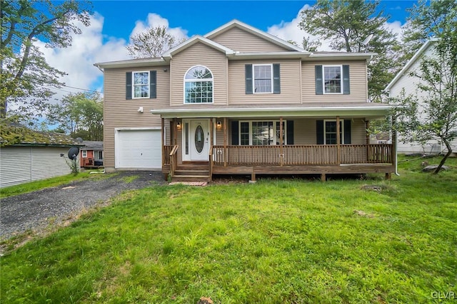 view of front of house with a garage, a porch, and a front yard