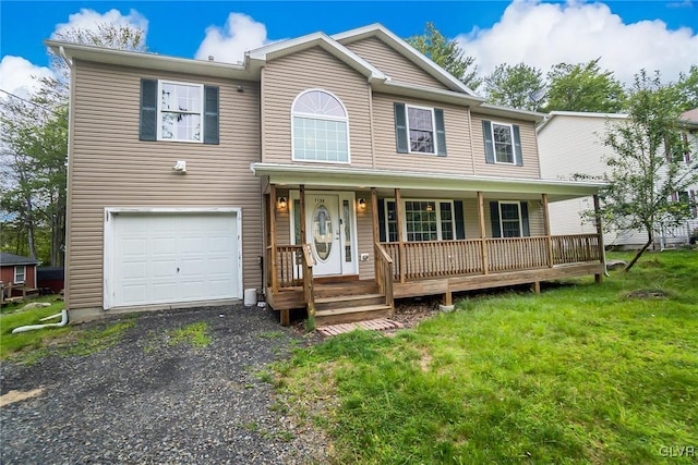 view of front of house featuring a garage, a porch, and a front lawn