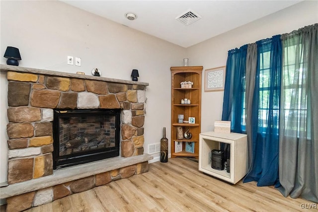 living room featuring a fireplace and light hardwood / wood-style flooring