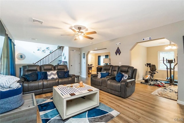 living room featuring light hardwood / wood-style flooring and ceiling fan