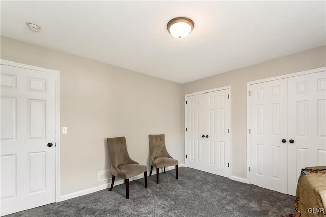 living area with dark colored carpet