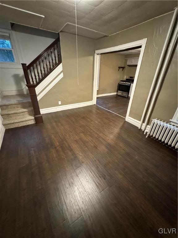 unfurnished room featuring dark hardwood / wood-style floors