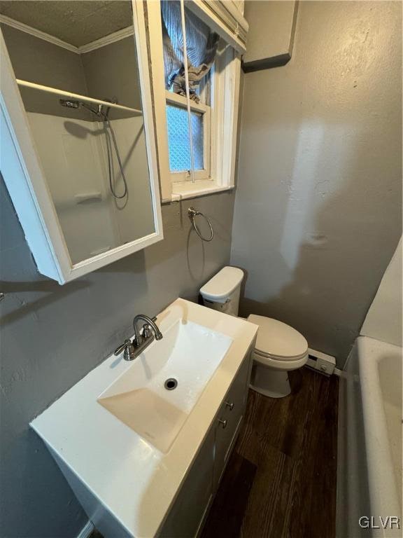 bathroom featuring toilet, vanity, ornamental molding, and hardwood / wood-style floors