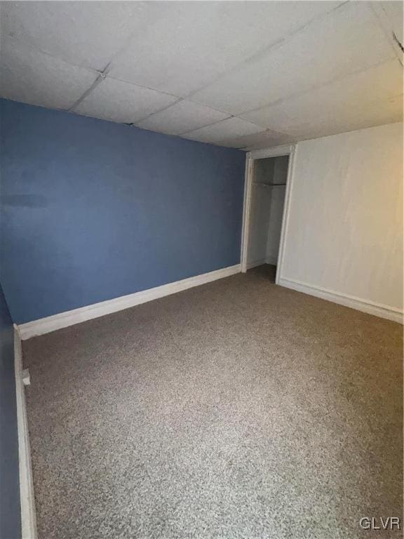 unfurnished bedroom with a drop ceiling and carpet floors