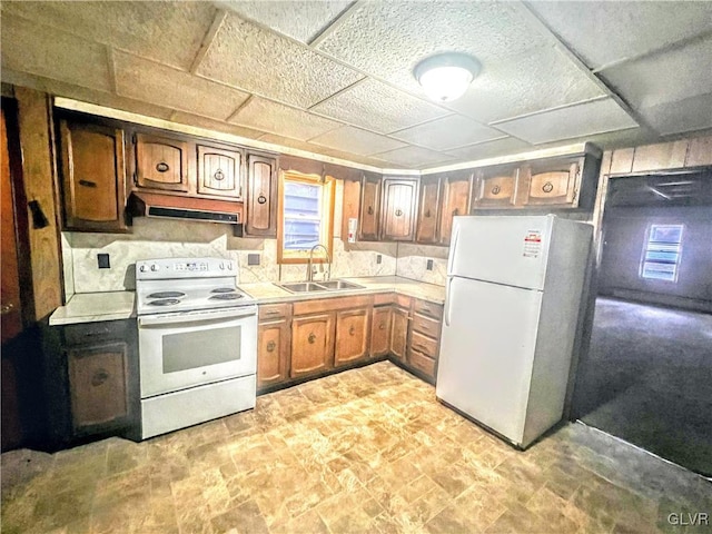 kitchen featuring white appliances and sink