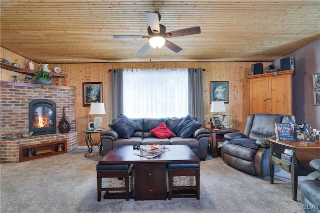 carpeted living room featuring wooden walls, ceiling fan, and wooden ceiling