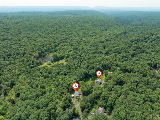 bird's eye view featuring a wooded view