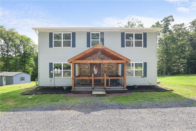 view of front of home with an outbuilding and a front lawn