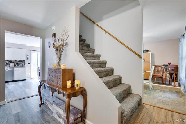 stairs with hardwood / wood-style floors