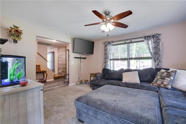 living room with ceiling fan and light hardwood / wood-style floors