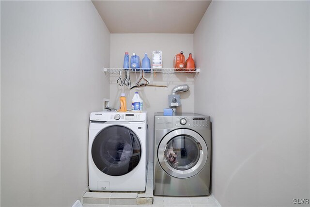 washroom featuring tile patterned flooring and washer and dryer