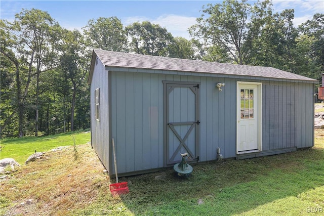 view of outdoor structure featuring a lawn