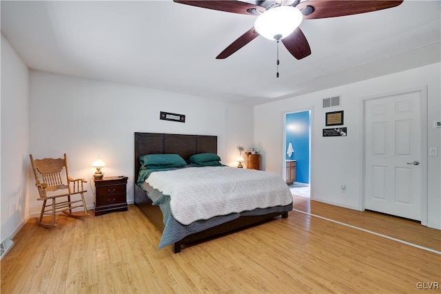 bedroom featuring connected bathroom, ceiling fan, and light wood-type flooring