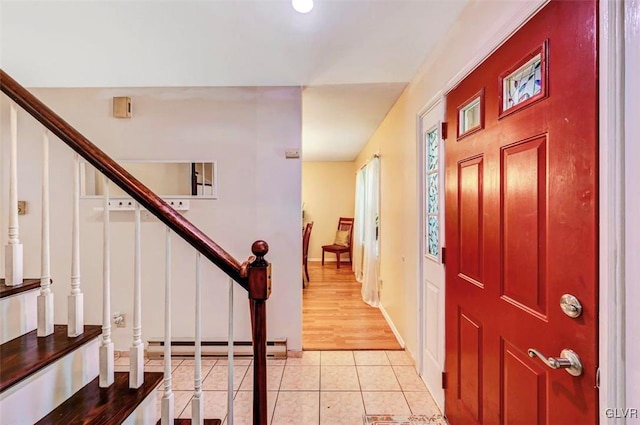 entrance foyer featuring a baseboard radiator and light wood-type flooring