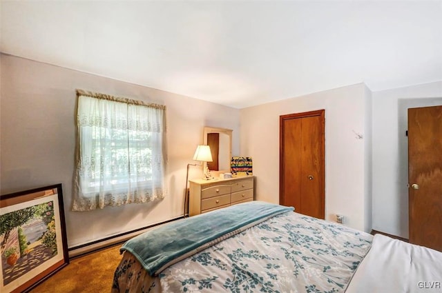 bedroom with carpet flooring and a baseboard heating unit