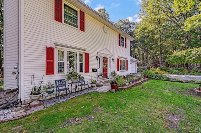 colonial inspired home with a front lawn