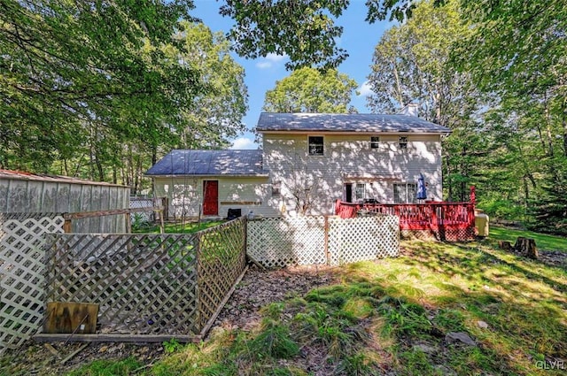 back of house featuring a wooden deck