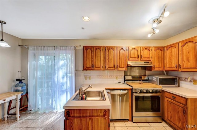 kitchen featuring sink, stainless steel appliances, decorative light fixtures, decorative backsplash, and light tile patterned flooring