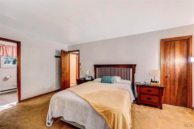 bedroom featuring light carpet, connected bathroom, and a baseboard radiator