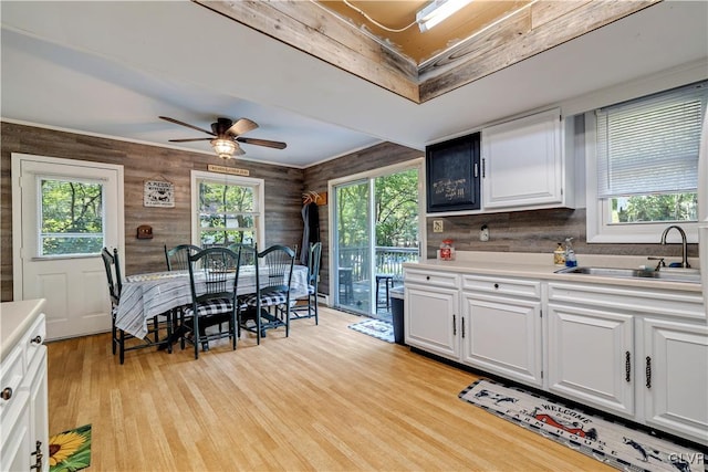 kitchen featuring light hardwood / wood-style flooring, sink, and white cabinetry