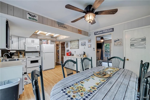 dining room with light hardwood / wood-style flooring, ornamental molding, sink, and ceiling fan