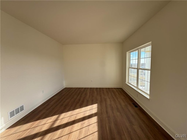 empty room featuring dark hardwood / wood-style floors