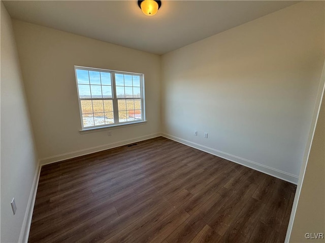 unfurnished room featuring dark hardwood / wood-style flooring