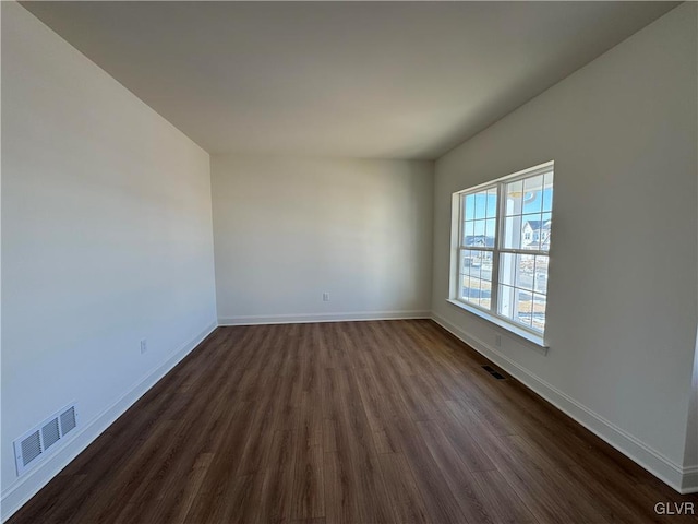 unfurnished room with dark hardwood / wood-style floors